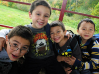 Four happy kids on hay ride wagon